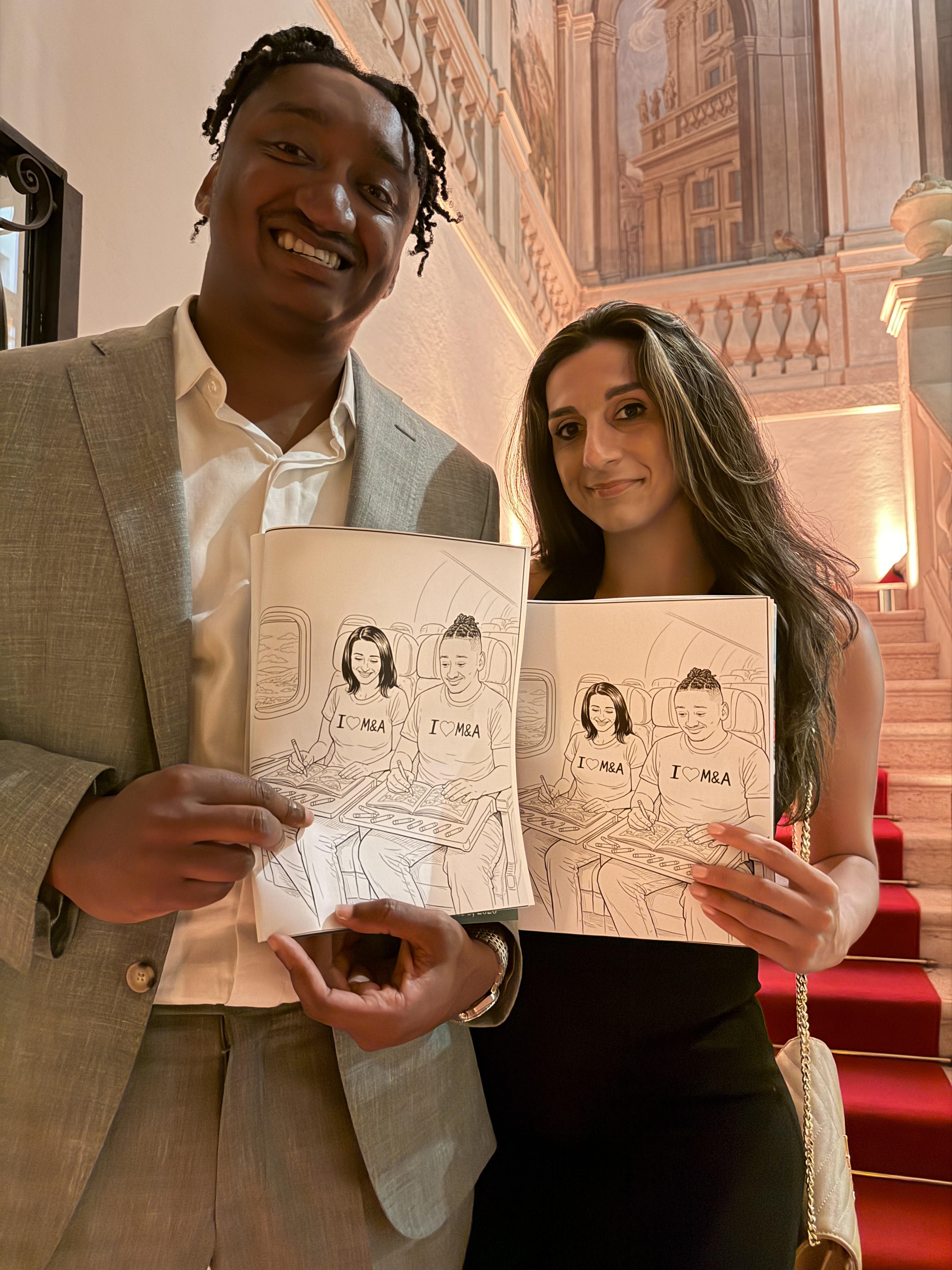 Couple holding their personalized coloring books at a wedding